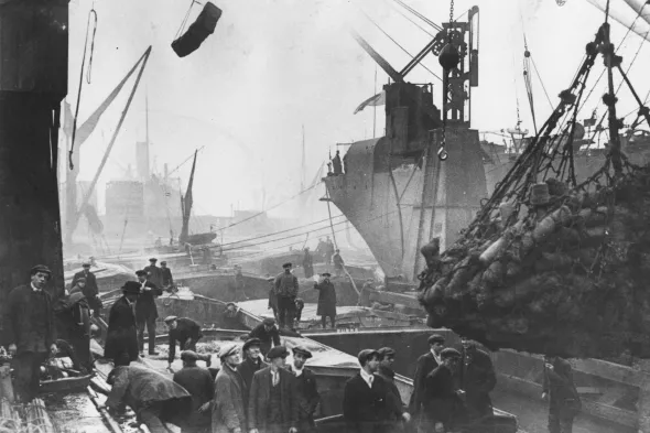 Archival image of busy port and cargo unloading