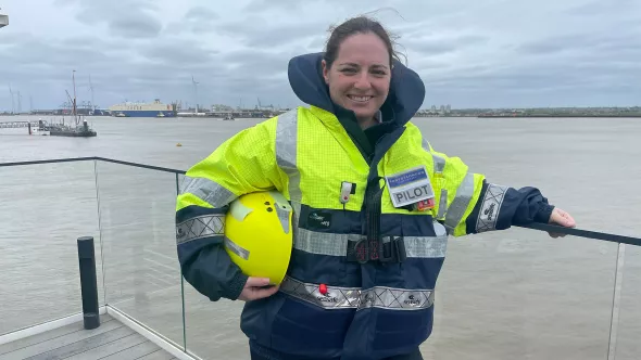 Captain Caz, a new PLA female Pilot with the River Thames in the background