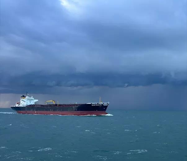 Vessel on the River Thames with stormy sky in background