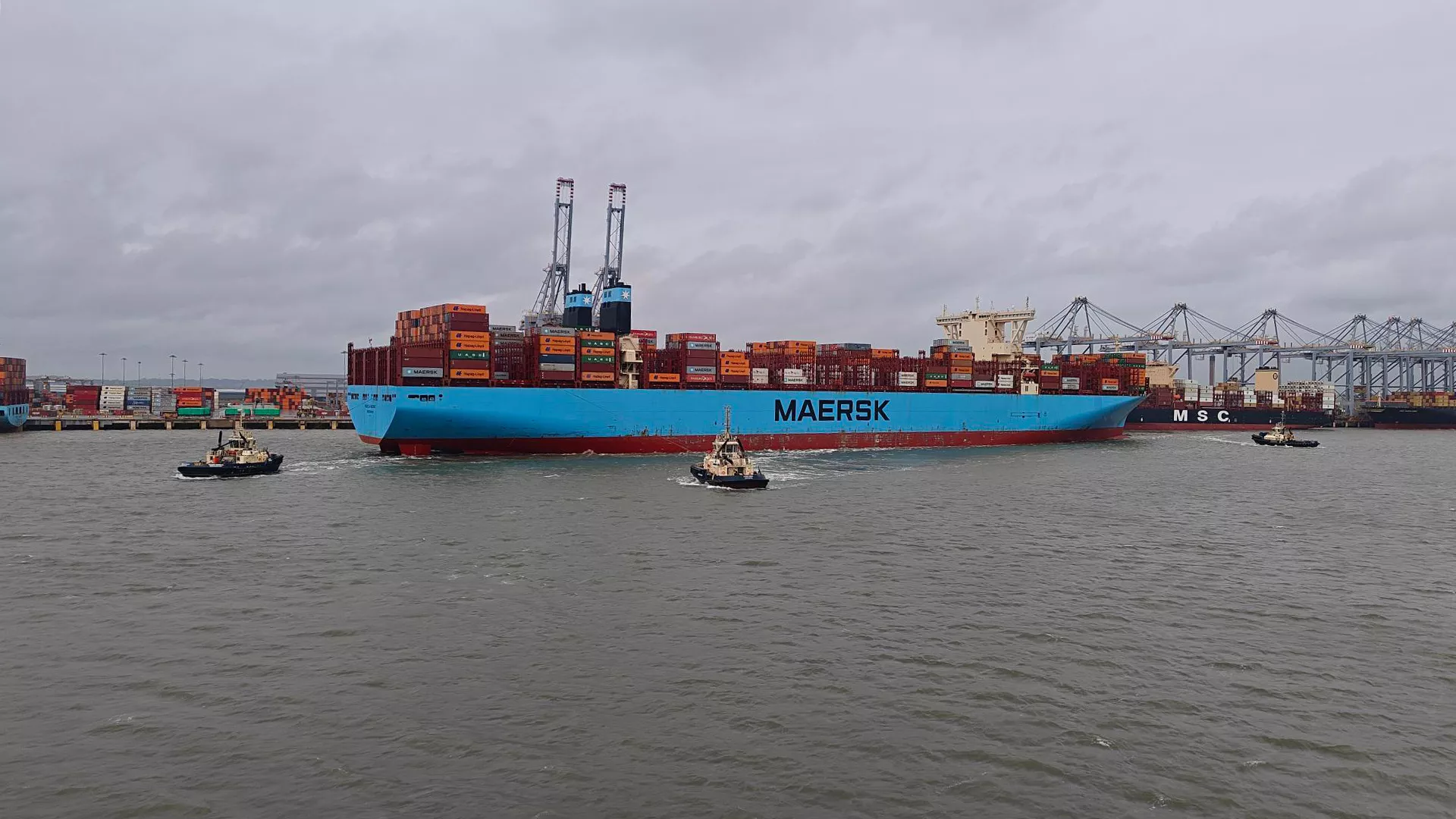 Vessel in the Port of London with three tugs