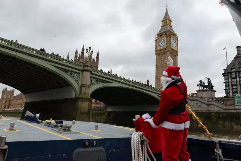 Santa on a boat waving in front of Big Ben 